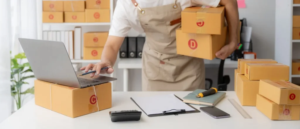 Person with boxes and laptop